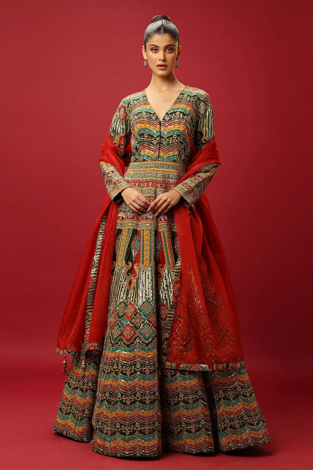 FERN GREEN AND RED CLASSIC MULTI COLOURED PRINTED ANARKALI GOWN SET WITH GOLD ZARI THREAD WORK PAIRED WITH A CONTRAST RED DUPATTA AND SEQUIN DETAILS.