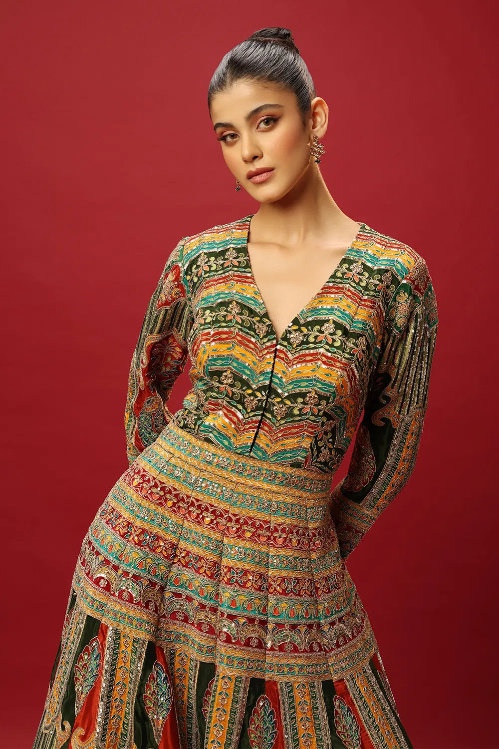FERN GREEN AND RED CLASSIC MULTI COLOURED PRINTED ANARKALI GOWN SET WITH GOLD ZARI THREAD WORK PAIRED WITH A CONTRAST RED DUPATTA AND SEQUIN DETAILS.
