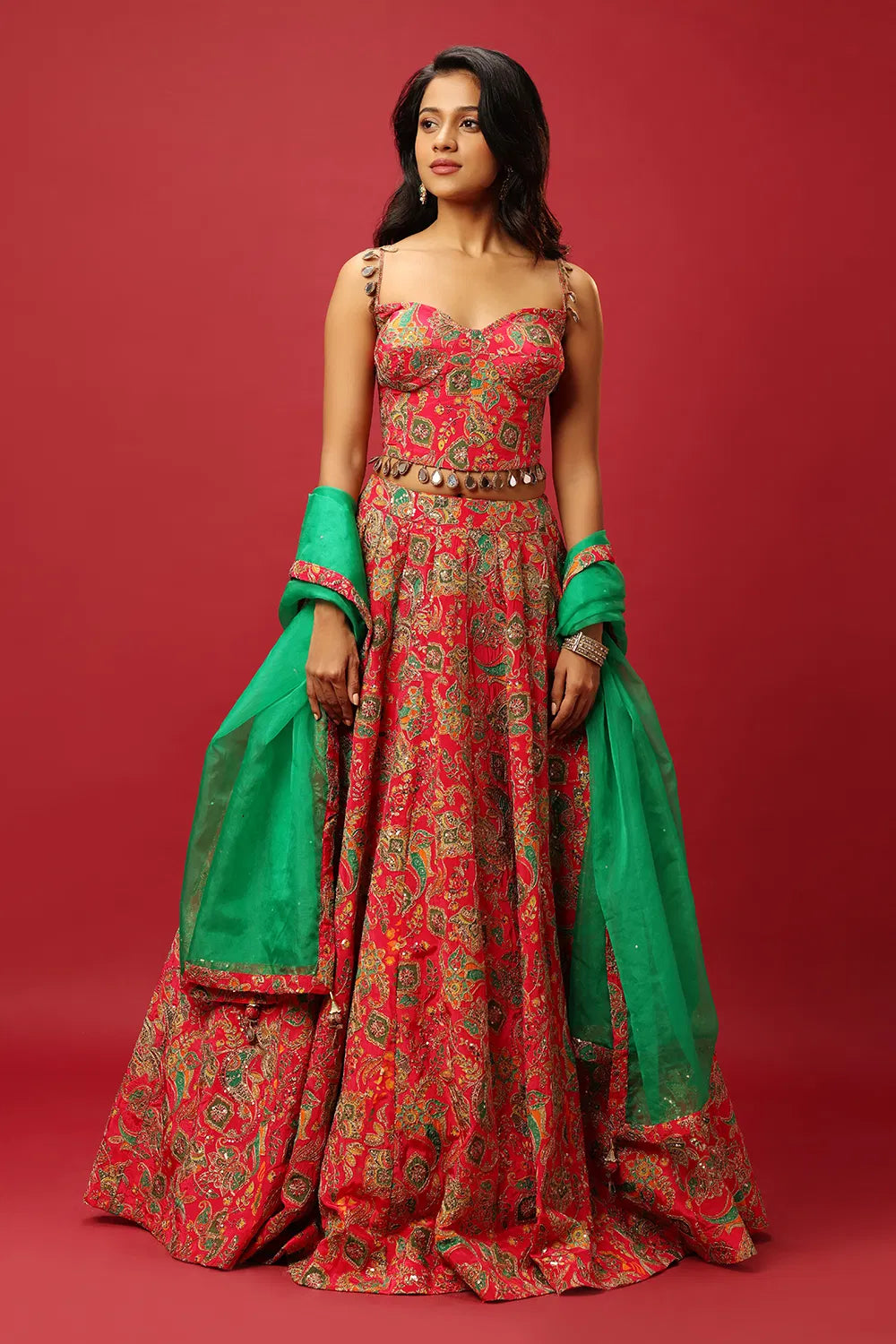 BRIGHT PINK CLASSIC MULTI COLOURED PRINTED LEHENGA SET WITH GOLD ZARI THREAD WORK PAIRED WITH A CONTRAST GREEN DUPATTA AND SEQUIN WORK EMBELLISHMENTS