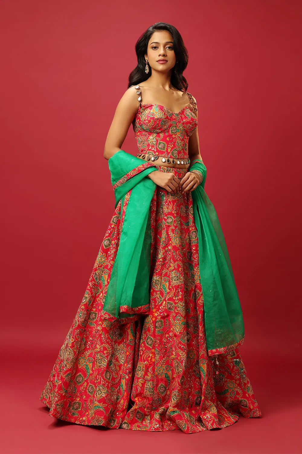 BRIGHT PINK CLASSIC MULTI COLOURED PRINTED LEHENGA SET WITH GOLD ZARI THREAD WORK PAIRED WITH A CONTRAST GREEN DUPATTA AND SEQUIN WORK EMBELLISHMENTS