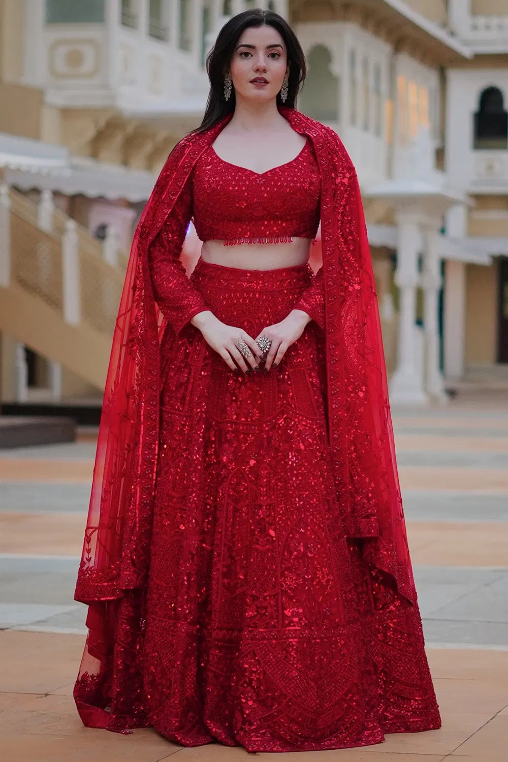 DEEP RED CLASSIC BRIDAL LEHENGA SET WITH ALL OVER PATTERNED EMBROIDERY PAIRED WITH A MATCHING DUPATTA AND SELF TONE CRYSTAL AND SEQUIN HIGHLIGHTS.
