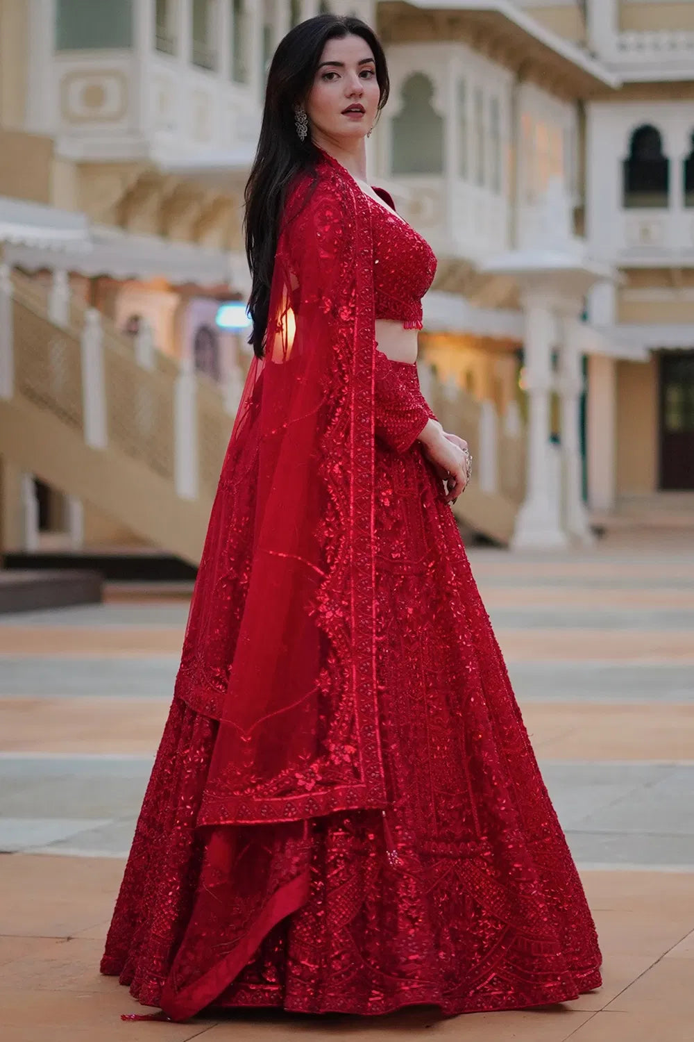 DEEP RED CLASSIC BRIDAL LEHENGA SET WITH ALL OVER PATTERNED EMBROIDERY PAIRED WITH A MATCHING DUPATTA AND SELF TONE CRYSTAL AND SEQUIN HIGHLIGHTS.