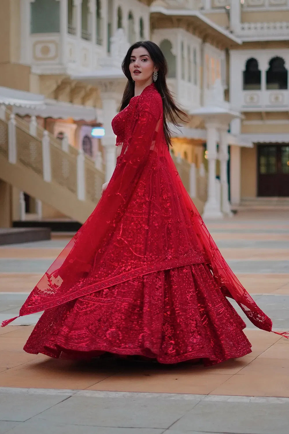 DEEP RED CLASSIC BRIDAL LEHENGA SET WITH ALL OVER PATTERNED EMBROIDERY PAIRED WITH A MATCHING DUPATTA AND SELF TONE CRYSTAL AND SEQUIN HIGHLIGHTS.