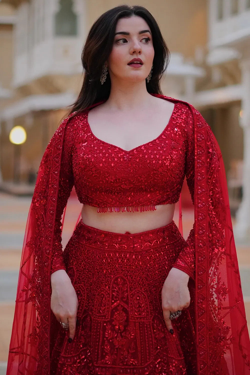 DEEP RED CLASSIC BRIDAL LEHENGA SET WITH ALL OVER PATTERNED EMBROIDERY PAIRED WITH A MATCHING DUPATTA AND SELF TONE CRYSTAL AND SEQUIN HIGHLIGHTS.